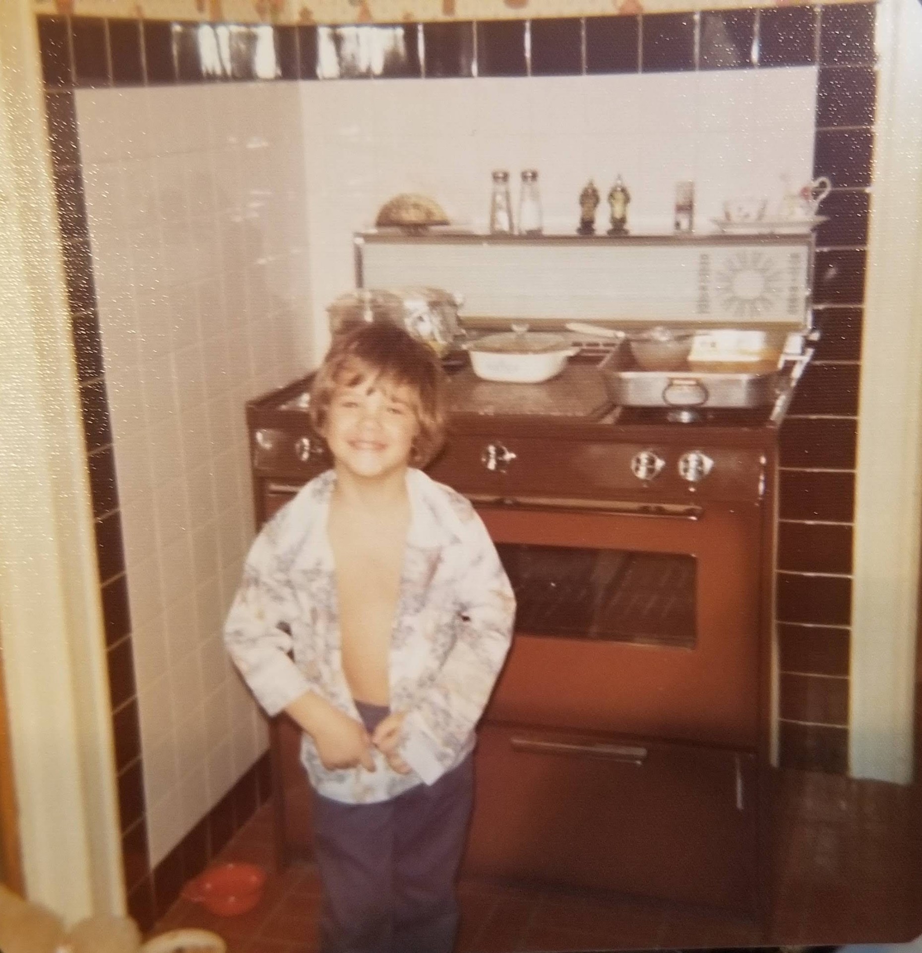 Young Peter Ingrasselino standing in his grandmother's kitchen
